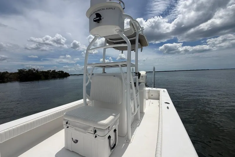 Slide: The Image of 2016 Dorado 25 SE boat on calm water under cloudy sky. - 15
