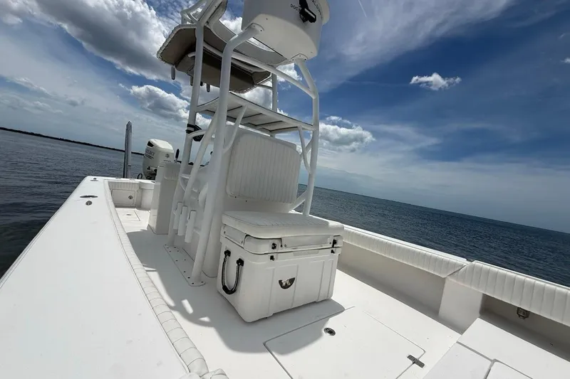 Slide: The Image of 2016 Dorado 25 SE boat on open water under a partly cloudy sky. - 17