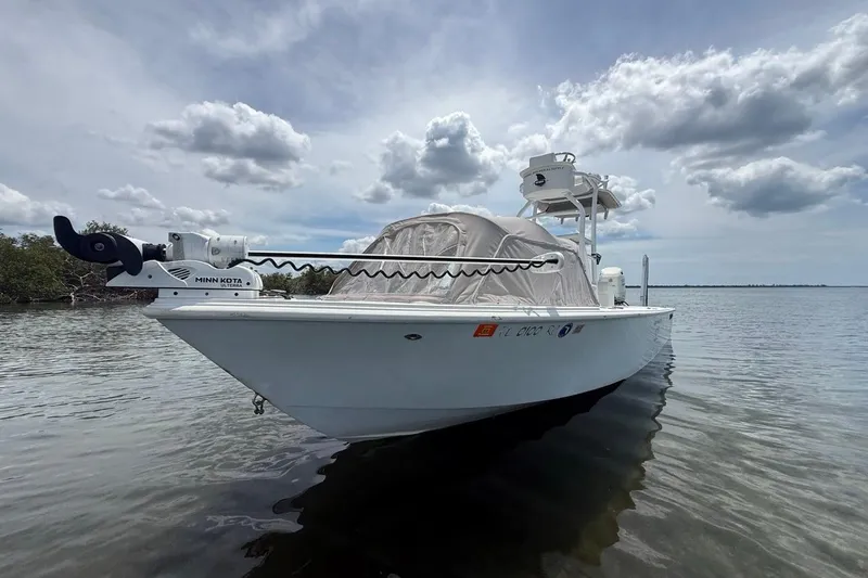 Slide: The Image of 2016 Dorado 25 SE boat on calm water under cloudy sky. - 2