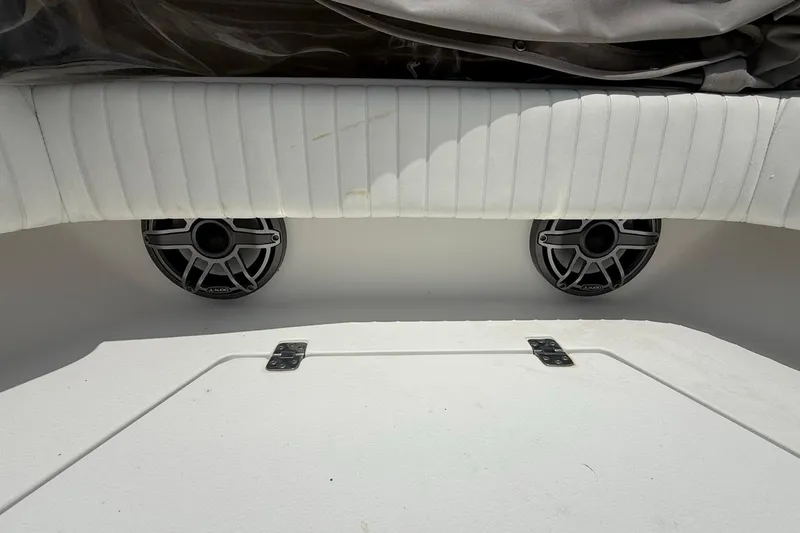 Slide: The Image of 2016 Dorado 25 SE boat interior with speakers and cushioned seating. - 21