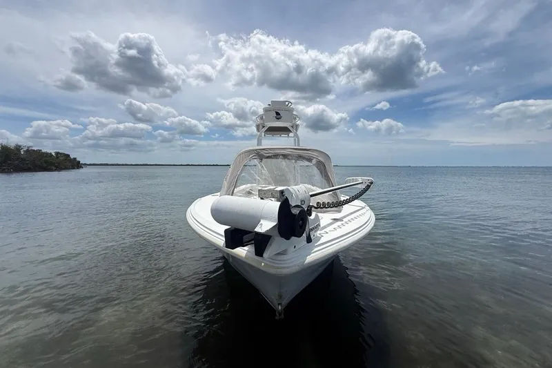 Slide: The Image of 2016 Dorado 25 SE boat on calm water under cloudy sky. - 4