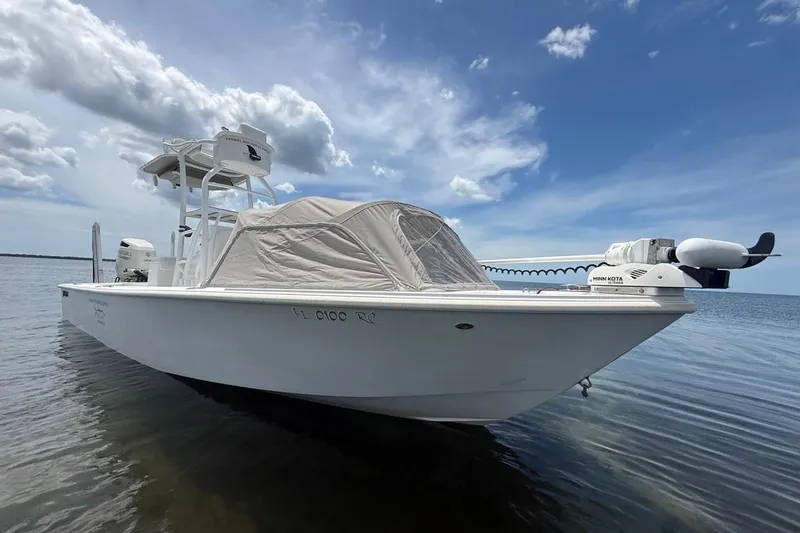 Slide: The Image of 2016 Dorado 25 SE boat on calm water under a partly cloudy sky. - 5