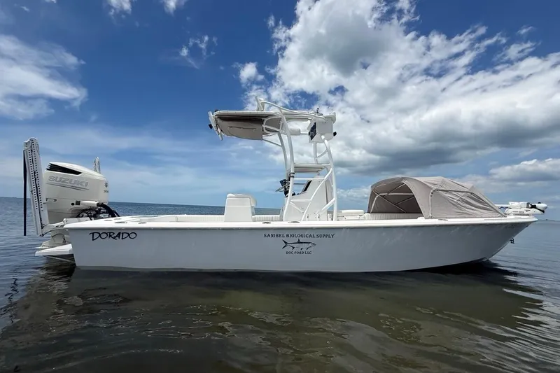 Slide: The Image of 2016 Dorado 25 SE boat with Suzuki engine on calm water under blue sky. - 6