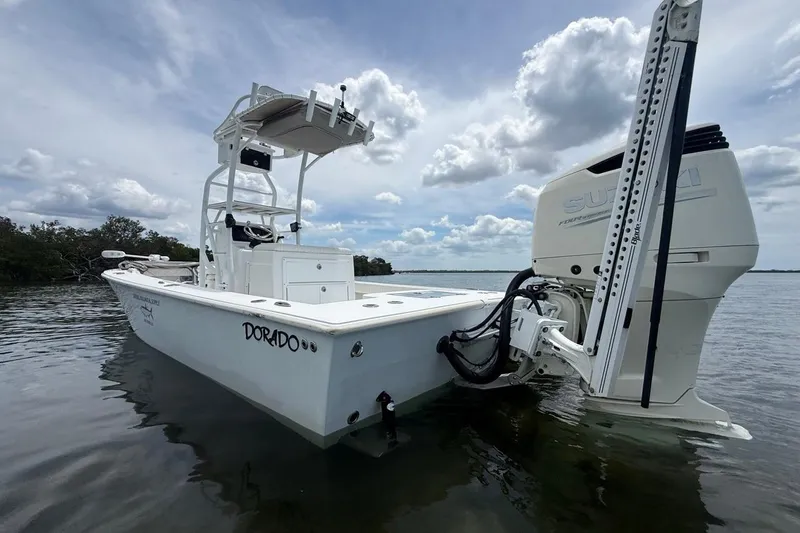Slide: The Image of 2016 Dorado 25 SE boat with Suzuki engine on calm water under cloudy sky. - 7