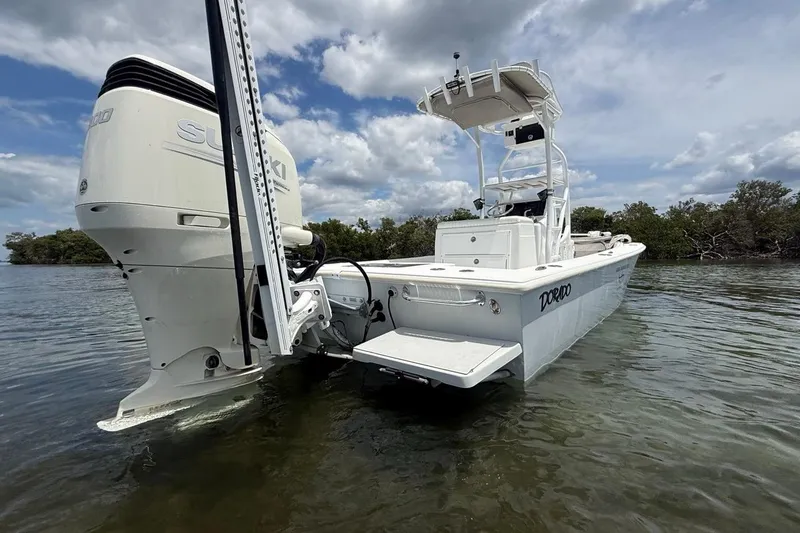 Slide: The Image of 2016 Dorado 25 SE boat with Suzuki engine in shallow water, under a cloudy sky. - 9
