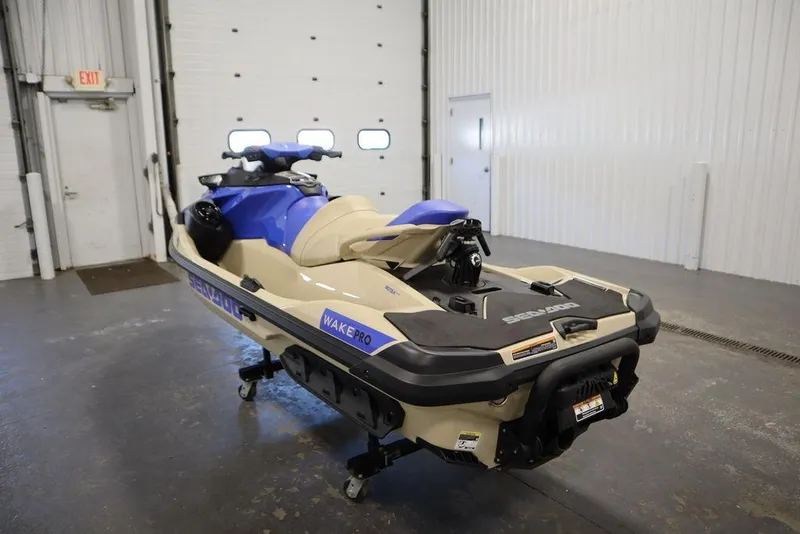Slide: The Image of 2025 Sea-Doo Wake Pro 230 jet ski in a garage setting. - 11
