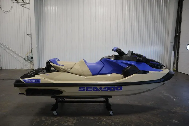 Slide: The Image of 2025 Sea-Doo Wake Pro 230 jet ski in a garage setting. - 12