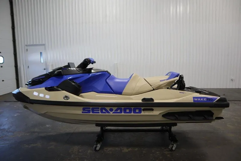 Slide: The Image of 2025 Sea-Doo Wake Pro 230 jet ski in a showroom, side view. - 21