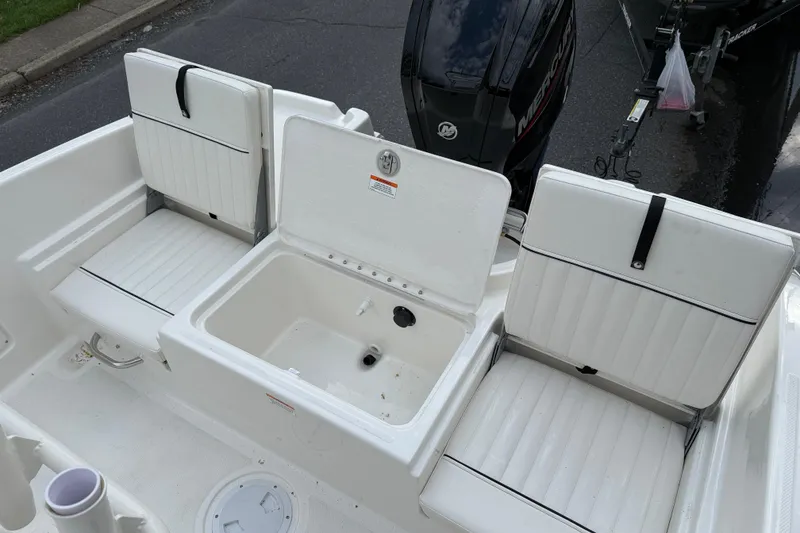 Slide: The Image of 2026 Bayliner Trophy T18 boat interior with white seating and storage compartment. - 10