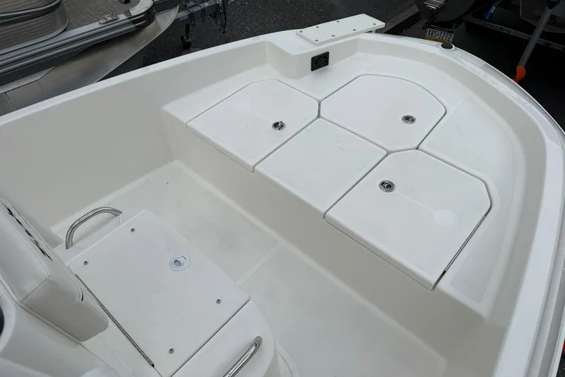 Slide: The Image of 2026 Bayliner Trophy T18 boat deck with storage compartments and seating. - 12