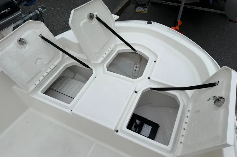 Slide: The Image of 2026 Bayliner Trophy T18 boat storage compartments open, showcasing spacious interior design. - 13