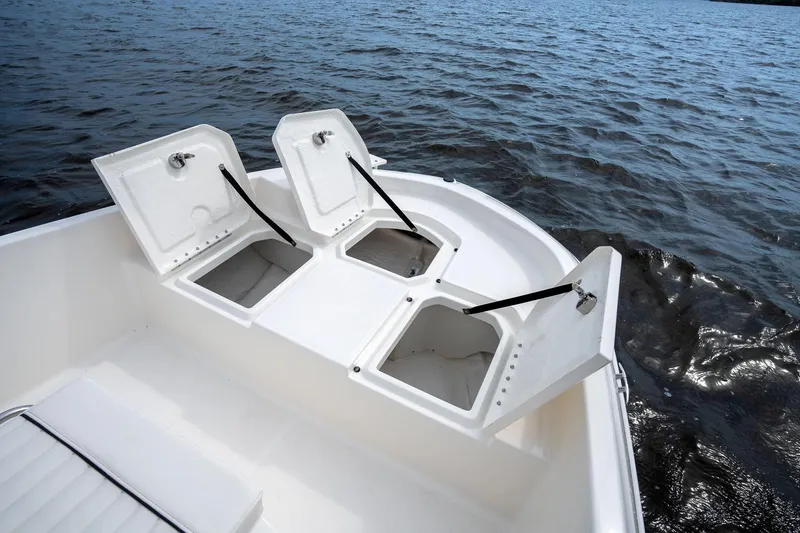 Slide: The Image of 2026 Bayliner Trophy T18 boat with Mercury engine, docked outdoors. - 5
