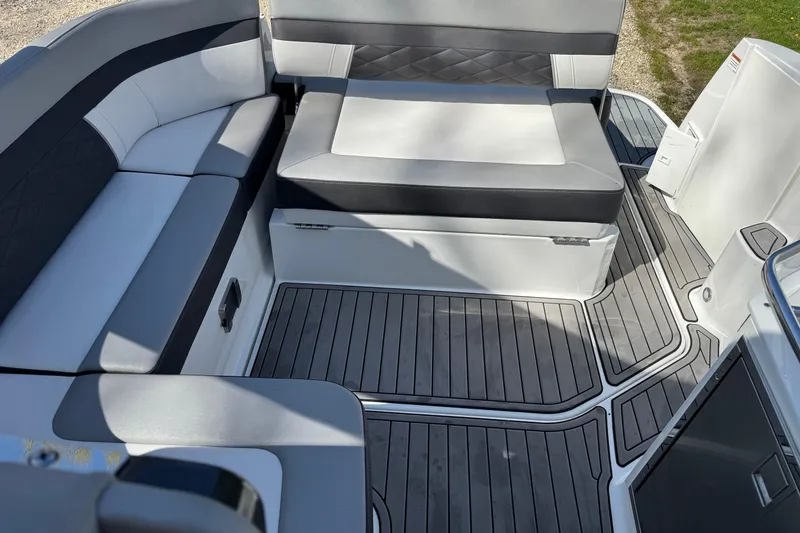 Slide: The Image of 2021 Monterey 295 Sport Yacht interior with sleek seating and modern flooring. - 11