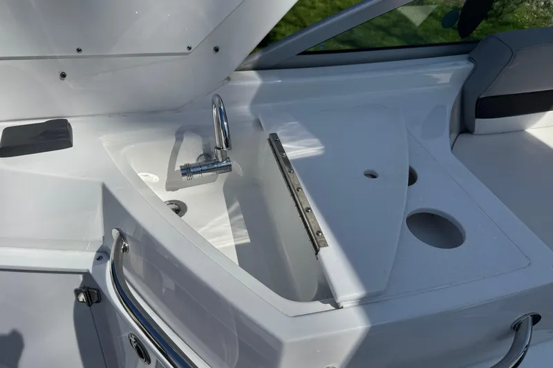 Slide: The Image of 2021 Monterey 295 Sport Yacht sink area with faucet and storage compartments. - 16