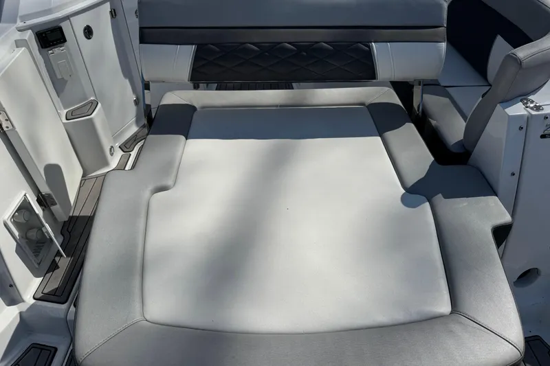 Slide: The Image of 2021 Monterey 295 Sport Yacht interior with gray cushioned seating area. - 17