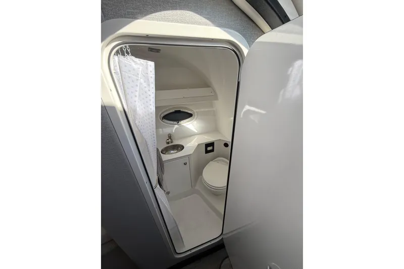 Slide: The Image of 2021 Monterey 295 Sport Yacht bathroom with shower, sink, and toilet. - 22