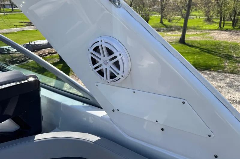 Slide: The Image of 2021 Monterey 295 Sport Yacht speaker detail on deck, sunny outdoor setting. - 23