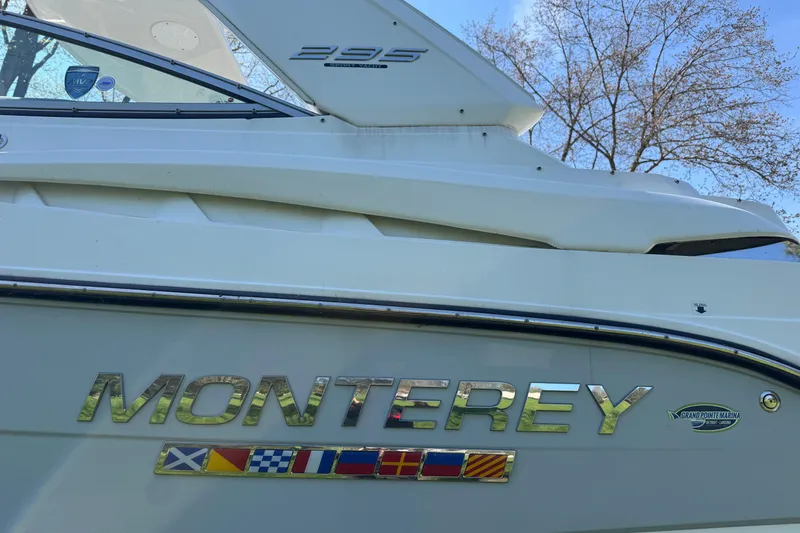 Slide: The Image of 2021 Monterey 295 Sport Yacht side view with logo and nautical flags. - 4