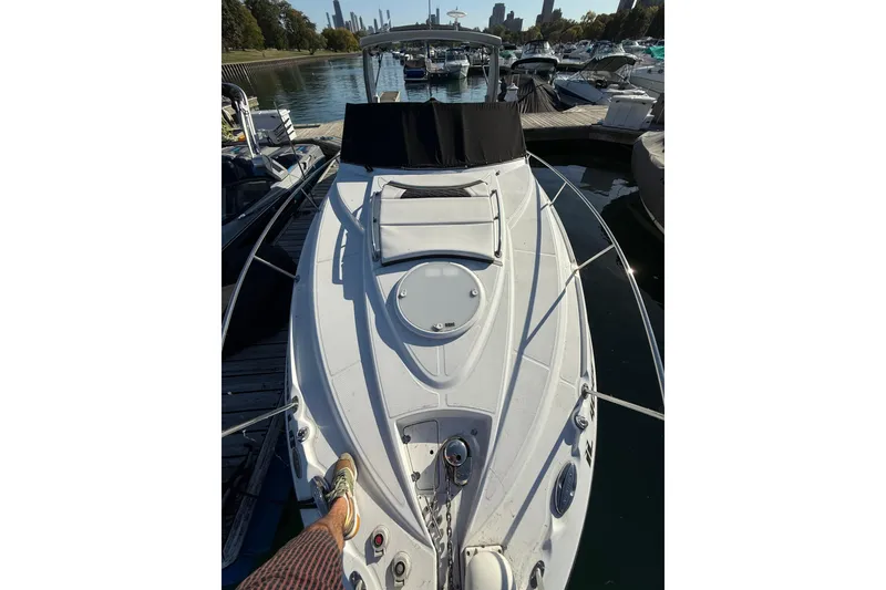 Slide: The Image of 2021 Monterey 295 Sport Yacht docked at a marina, viewed from the bow. - 5