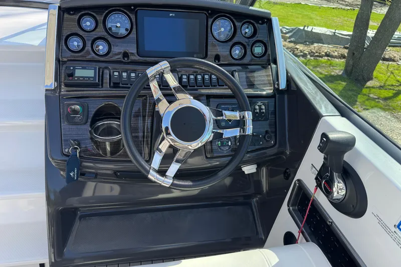 Slide: The Image of Cockpit of 2021 Monterey 295 Sport Yacht with steering wheel and control panel. - 7