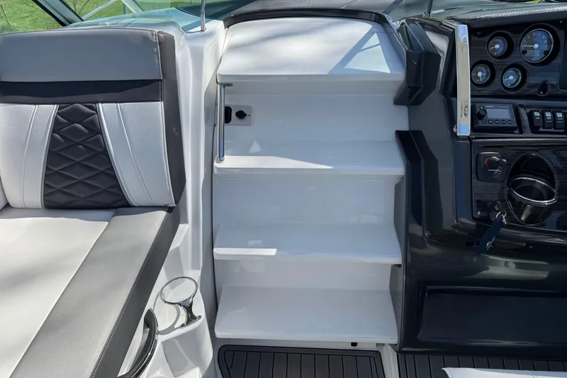 Slide: The Image of Interior of 2021 Monterey 295 Sport Yacht showing seating and control panel. - 9