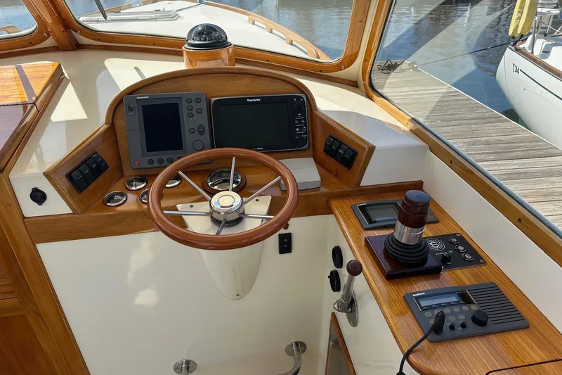 Slide: The Image of Helm of 1996 Hinckley Picnic Boat 36 Classic with wooden steering wheel and navigation equipment. - 10