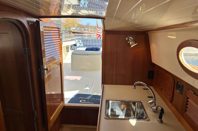 Slide: The Image of Interior of a 1996 Hinckley Picnic Boat 36 Classic with wooden cabinetry and sink. - 12