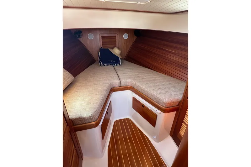 Slide: The Image of Interior cabin of 1996 Hinckley Picnic Boat 36 Classic with wooden paneling and cozy bedding. - 16