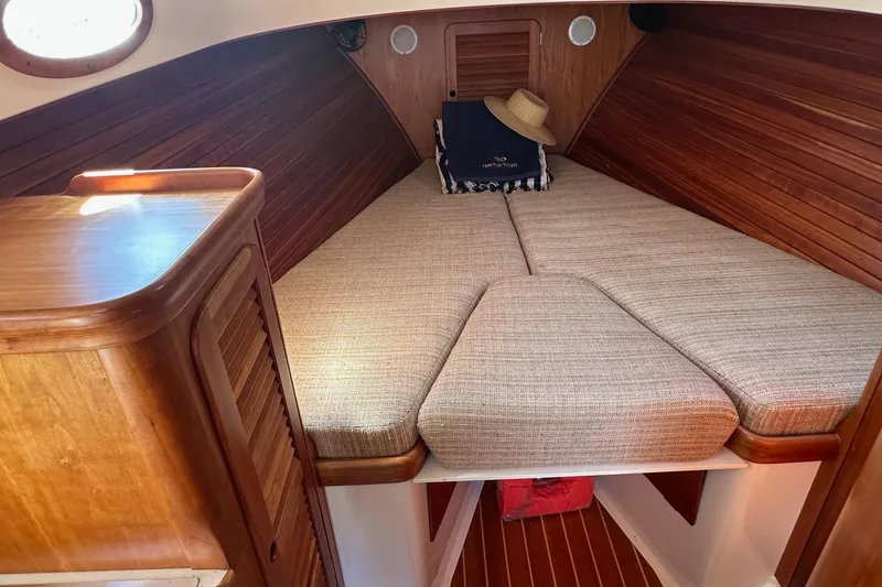 Slide: The Image of Cozy cabin interior of 1996 Hinckley Picnic Boat 36 Classic with wooden finish and cushions. - 17