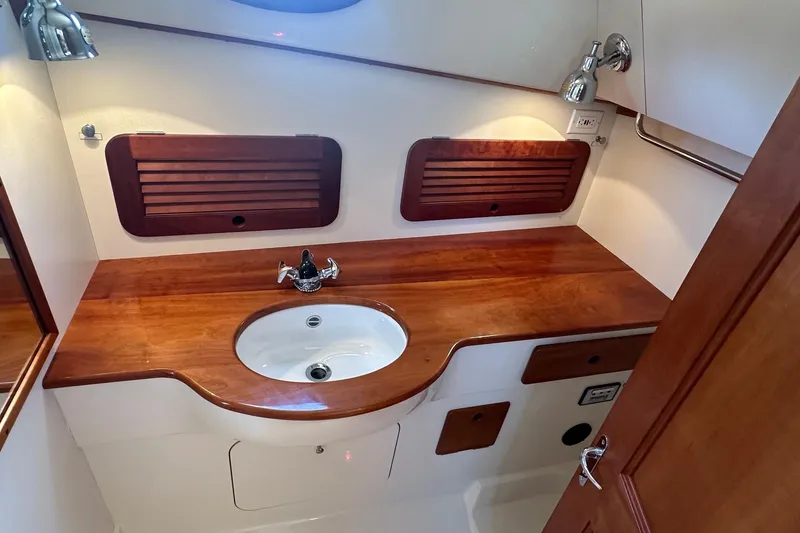 Slide: The Image of Hinckley Picnic Boat 36 Classic 1996 interior with wooden countertop and sink. - 19