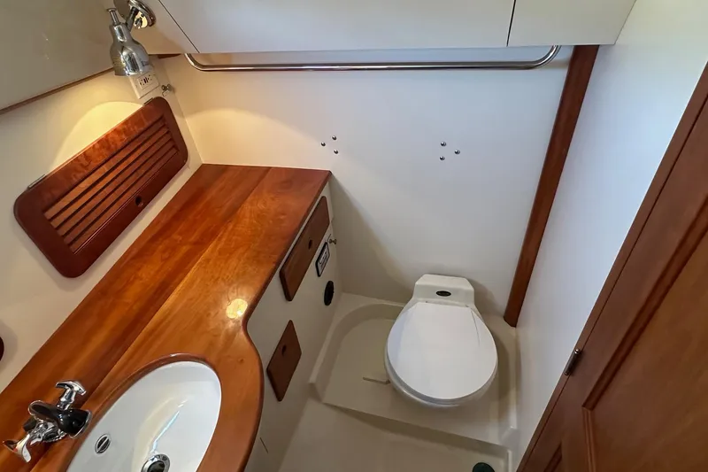 Slide: The Image of Hinckley Picnic Boat 36 Classic 1996 bathroom with wooden countertop and modern fixtures. - 20