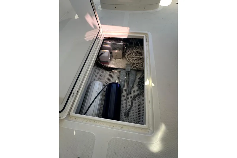 Slide: The Image of Storage compartment of a 1996 Hinckley Picnic Boat 36 Classic, featuring ropes and equipment. - 25