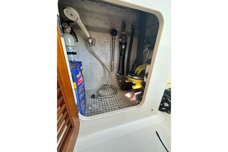Slide: The Image of Storage compartment of a 1996 Hinckley Picnic Boat 36 Classic with equipment and supplies. - 27