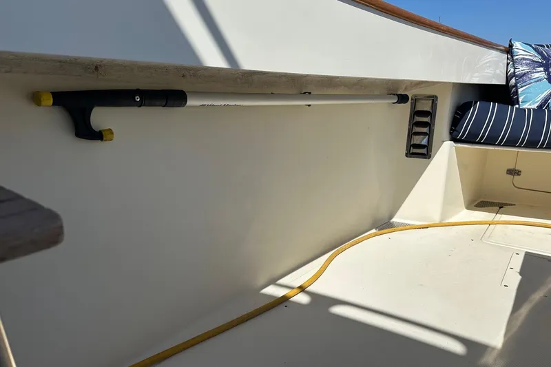 Slide: The Image of Interior of 1996 Hinckley Picnic Boat 36 Classic with seating and boat hook. - 28