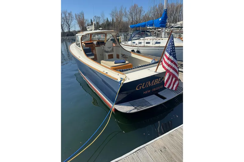 Slide: The Image of 1996 Hinckley Picnic Boat 36 Classic docked, displaying American flag, named "GUMBEAUX." - 3