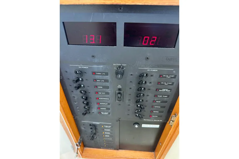 Slide: The Image of Electrical control panel of a 1996 Hinckley Picnic Boat 36 Classic, displaying voltage readings. - 30