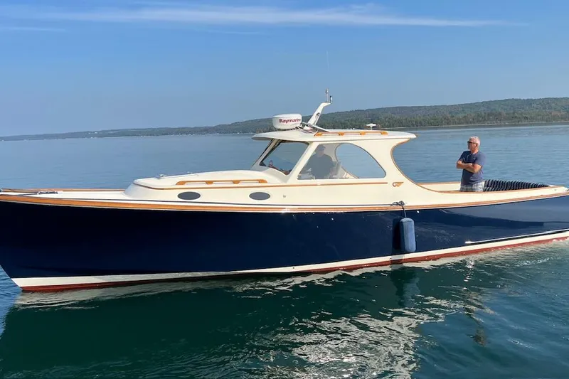 Slide: The Image of 1996 Hinckley Picnic Boat 36 Classic cruising on calm waters with scenic background. - 32