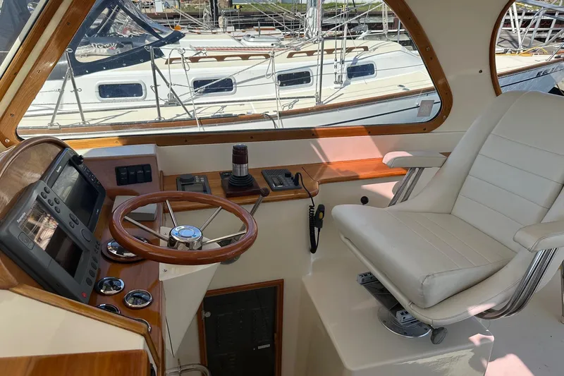 Slide: The Image of Helm of 1996 Hinckley Picnic Boat 36 Classic with steering wheel and navigation equipment. - 9