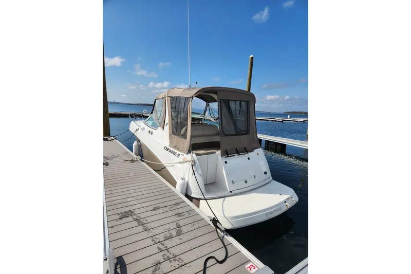 Slide: The Image of 2004 Four Winns 268 Vista boat docked at marina under clear blue sky. - 11
