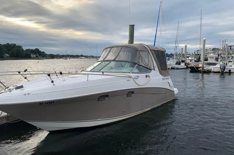Slide: The Image of 2004 Four Winns 268 Vista boat docked in a marina under cloudy skies. - 13
