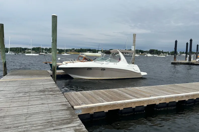 Slide: The Image of 2004 Four Winns 268 Vista boat docked at a marina with overcast skies. - 14