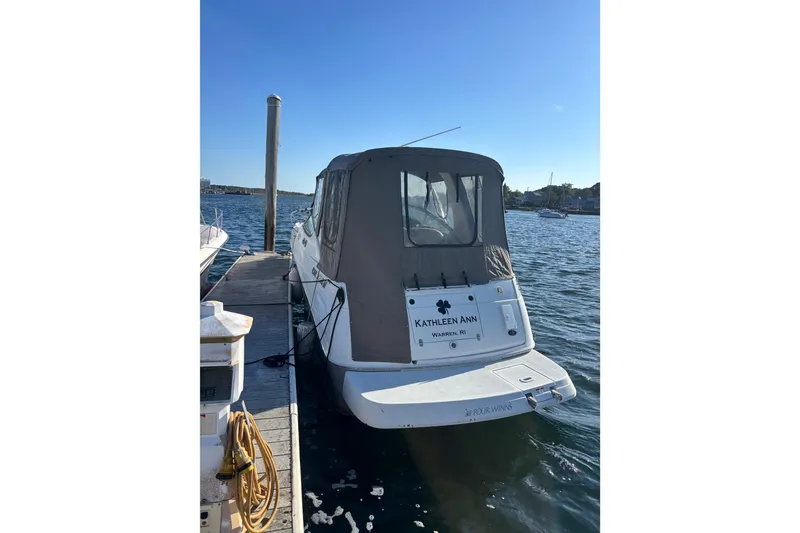Slide: The Image of 2004 Four Winns 268 Vista boat docked at marina, rear view. - 17