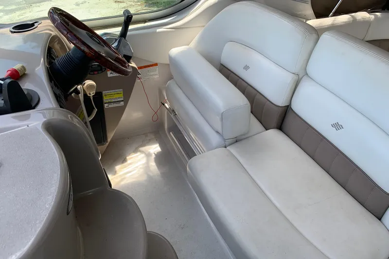 Slide: The Image of Interior of 2004 Four Winns 268 Vista boat with white seating and steering wheel. - 5