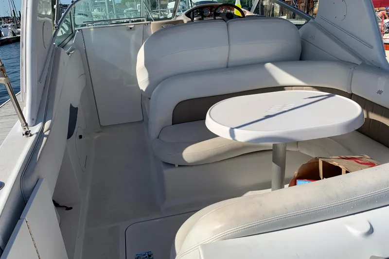 Slide: The Image of 2004 Four Winns 268 Vista boat interior with white seating and round table. - 8