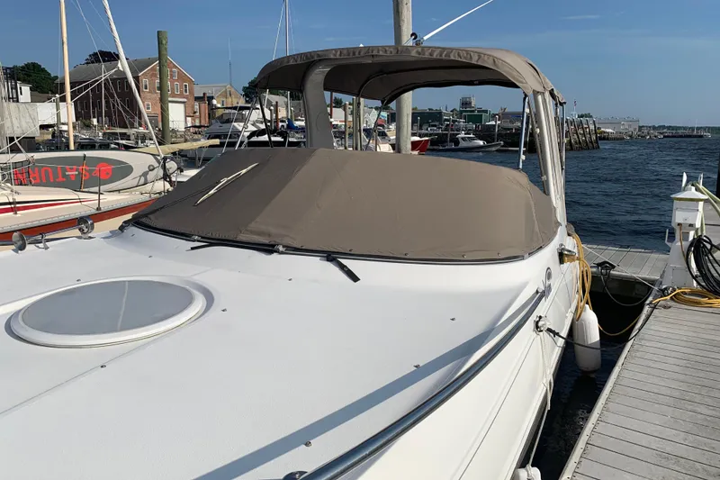 Slide: The Image of 2004 Four Winns 268 Vista boat docked at a marina, covered and ready for use. - 9