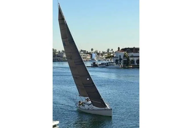 The Image of Sailboat "Cape Bay Fast 40" from 1983 navigating a calm waterway. - 1
