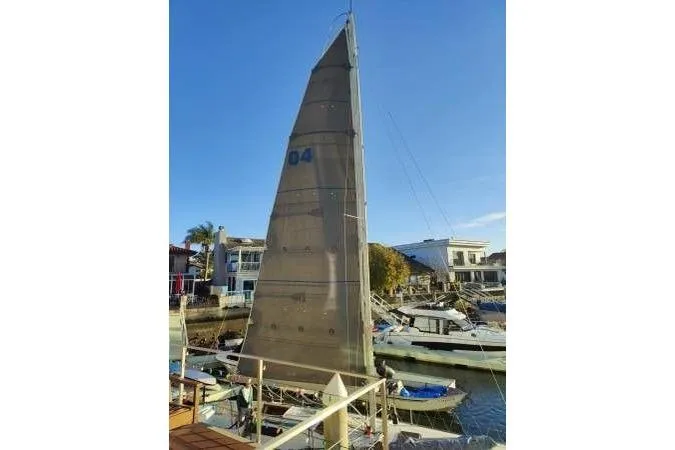 Slide: The Image of 1983 Cape Bay Fast 40 sailboat docked in a sunny marina. - 11