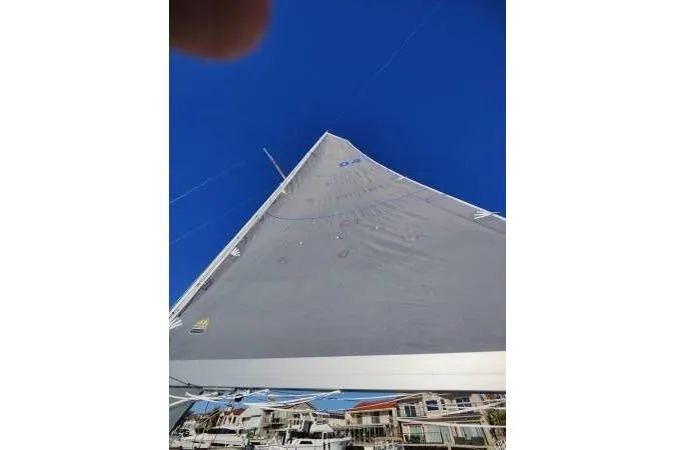 Slide: The Image of Sailboat with gray sail against blue sky, Cape Bay Fast 40, 1983 model. - 13