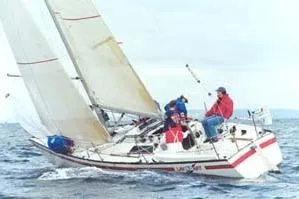 Slide: The Image of Sailboat Cape Bay Fast 40, 1983 model, navigating ocean waters with crew onboard. - 4