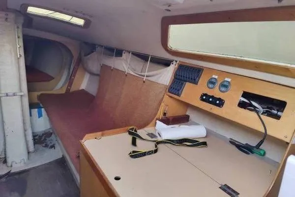 Slide: The Image of Interior of a 1983 Cape Bay Fast 40 sailboat, featuring a cozy cabin and navigation instruments. - 5